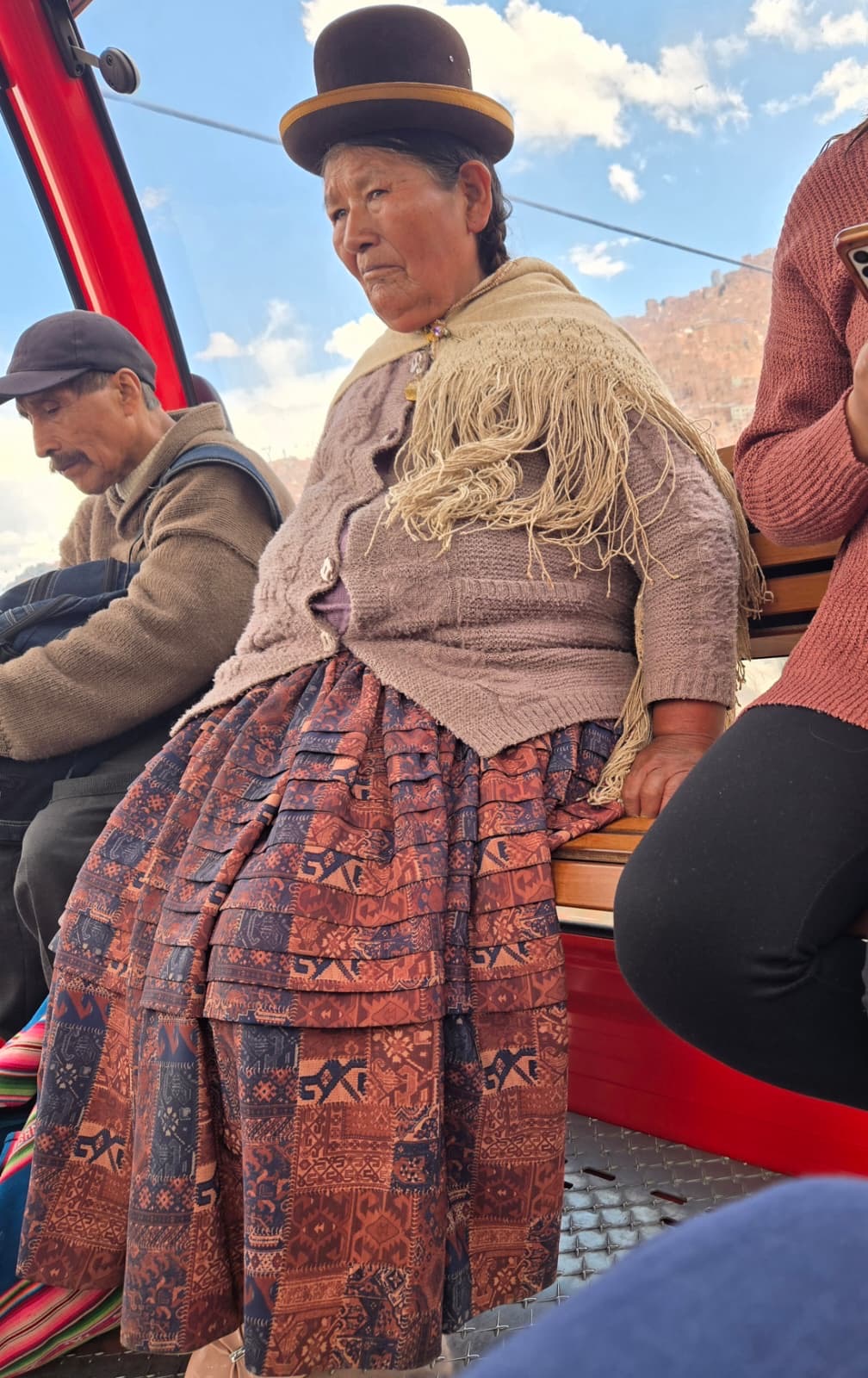 Traditional Bolivian cholita riding the La Paz gondola