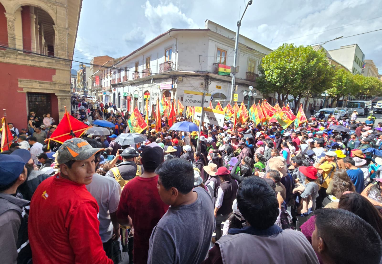 Procession crowd filling the La Paz streets with colorful flags