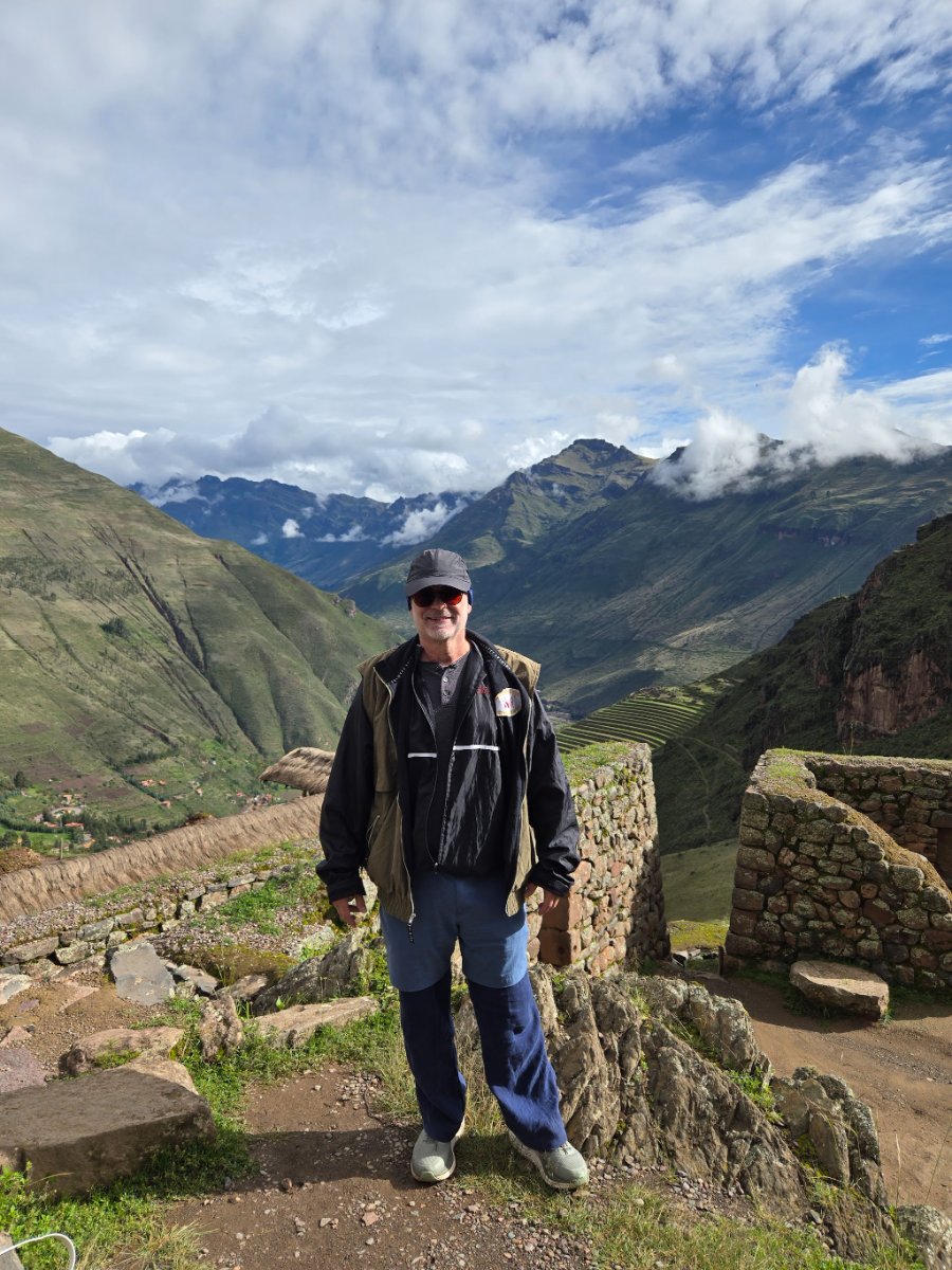 A narrow, illuminated alleyway at night in Cusco